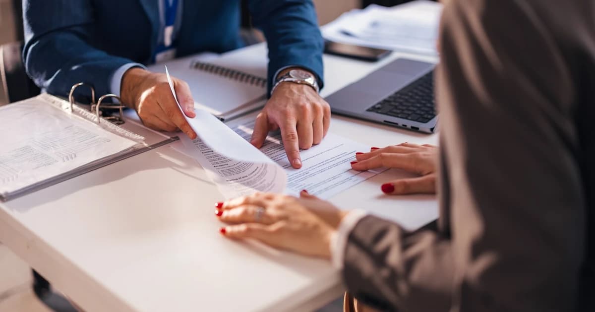 Lender reviewing loan documents and underwriting paperwork for a private real estate loan with a capital partner
